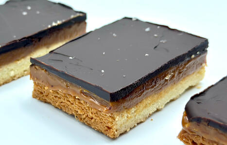 Worldwide popular vanilla shortbread topped with chewy caramel, rich dark chocolate ganache and sprinkle of flaky sea salt